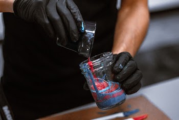 Photo of Person Combining Acrylic Paints in Mason Jar