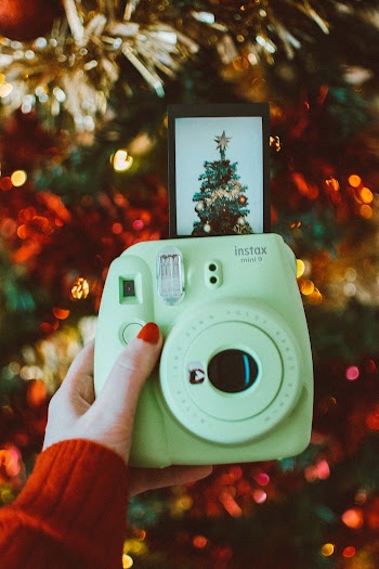 Photo of Person Holding an Instant Camera