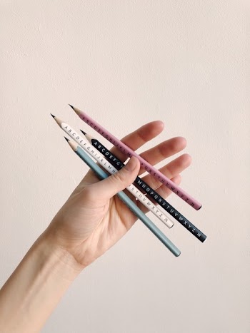 Photo of Person Holding Assorted Pencils