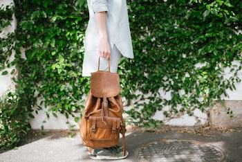 Photo Of Person Holding Backpack