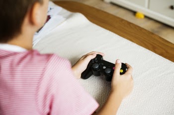 Photo of Person Holding Black Wireless Controller