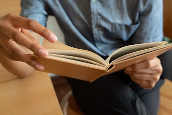 Photo Of Person Holding Book