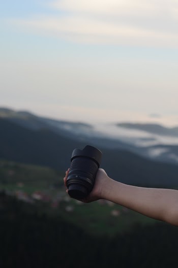 Photo of Person Holding Camera Lens