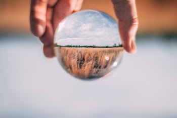 Photo of Person Holding Clear Glass Ball