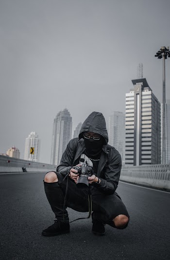 Photo of Person Holding DSLR Camera