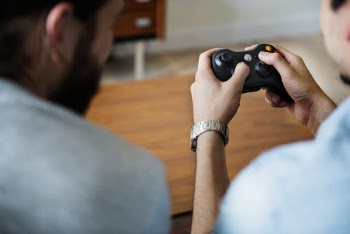 Photo of Person Holding Gamepad