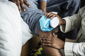 Photo of Person Holding Ice Bag