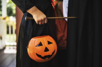 Photo of Person Holding Jack O' Lantern Bucket