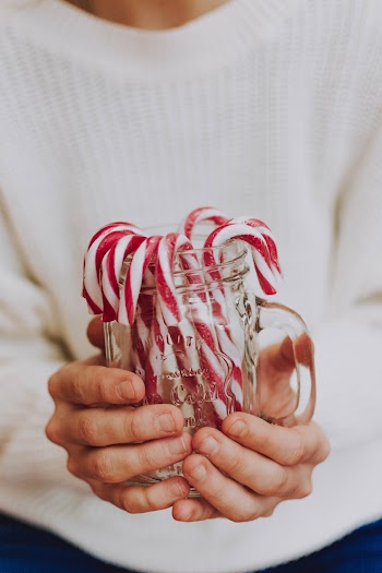 Photo Of Person Holding Jar With Candies