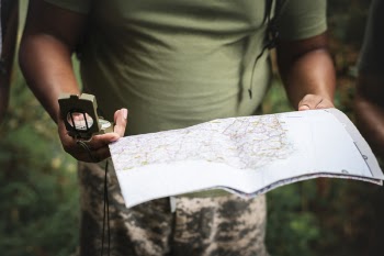 Photo of Person Holding Map and Compass