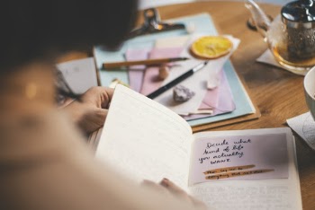 Photo Of Person Holding Notebook