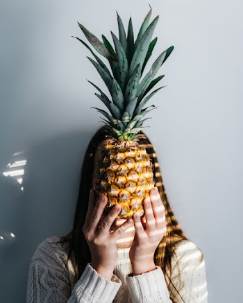 Photo of Person Holding Pineapple Fruit in Front of Face