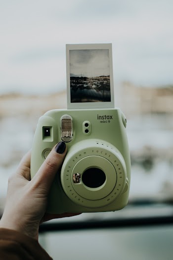 Photo Of Person Holding Polaroid