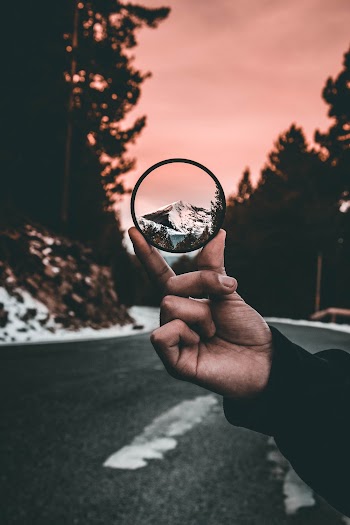 Photo of Person Holding Round Black Lens