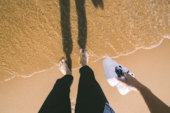 Photo of Person Holding Sneakers 