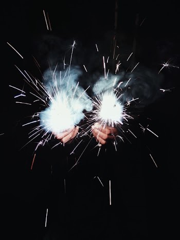 Photo of Person Holding Sparklers