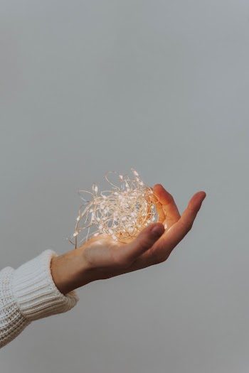Photo Of Person Holding String Lights