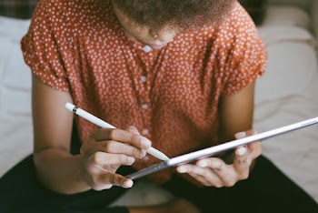 Photo of Person Holding Tablet