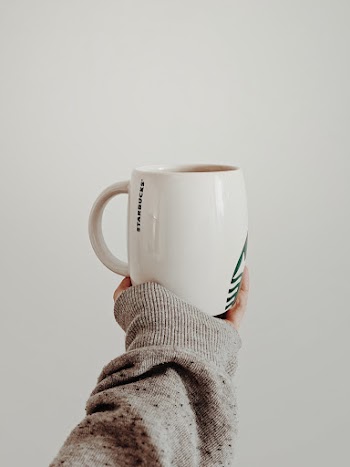 Photo of Person Holding White Ceramic Mug