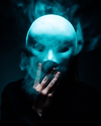 Photo of Person Holding White Mask