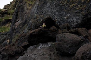 Photo of Person Meditating on Top of Rock