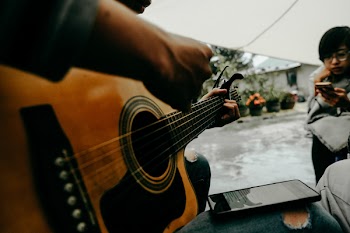 Photo of Person Playing Guitar