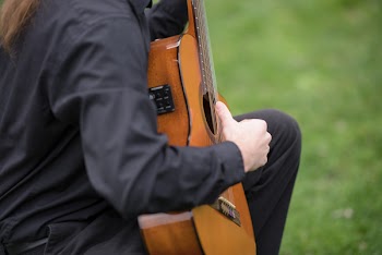 Photo of Person Playing Guitar