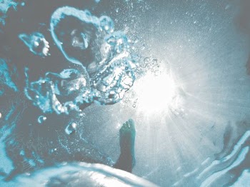 photo of person's foot on water