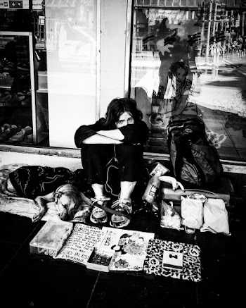 Photo of Person Sitting Near Glass Wall