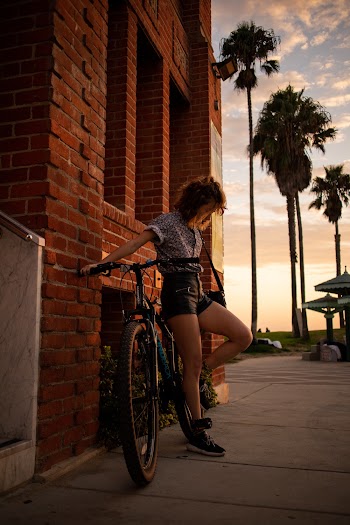Photo Of Person Standing Beside Bicycle