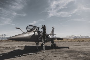 Photo Of Person Standing Beside Fighter Jet