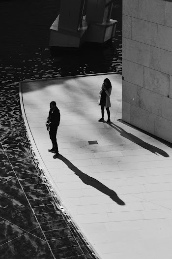 Photo Of Person Standing Beside Wall