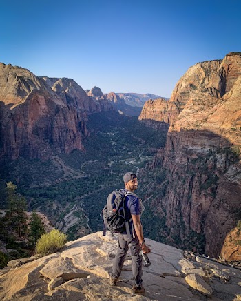 Photo Of Person Standing On Cliff