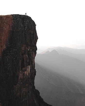 Photo Of Person Standing On Cliff