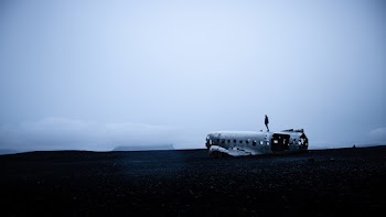 Photo of Person Standing On Crashed Plane