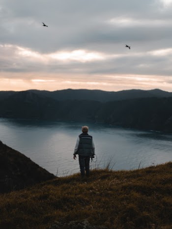 Photo of Person Standing on Grass