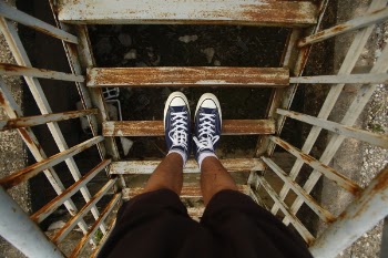 Photo of Person Standing on Metal Staircase