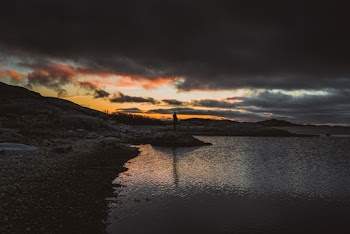 Photo of Person Standing On Rock