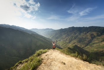 Photo of Person Standing On Top Of Mountain