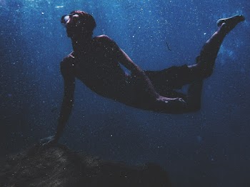 Photo of Person Swimming Underwater