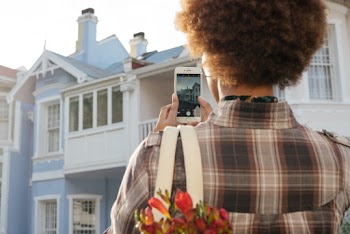 Photo Of Person Taking Picture Of House