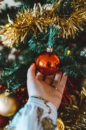 Photo Of Person Touching Christmas Ball