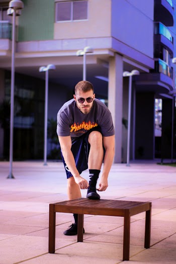 Photo of Person Tying His Shoes