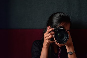 Photo of Person Using Nikon Dslr Camera