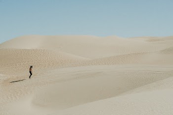 Photo Of Person Walking On Desert