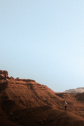Photo Of Person Walking On Desert