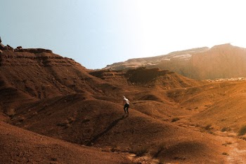 Photo Of Person Walking On Desert
