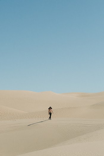 Photo Of Person Walking On Desert