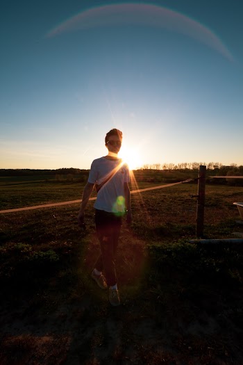 Photo Of Person Walking On Grass