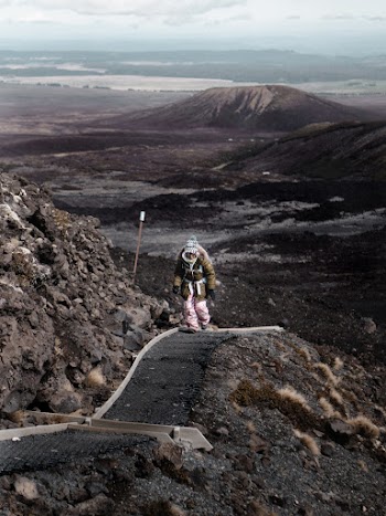 Photo of Person Walking on Pathway Near Rocks